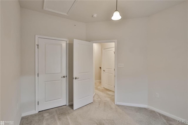 unfurnished bedroom with light carpet and baseboards