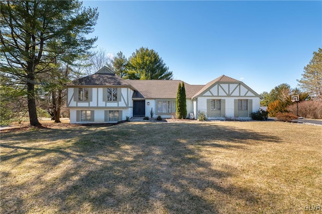 english style home with a front yard