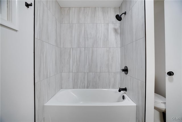 bathroom with toilet and tub / shower combination