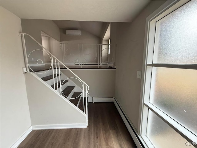 staircase with a baseboard radiator, a healthy amount of sunlight, and wood finished floors