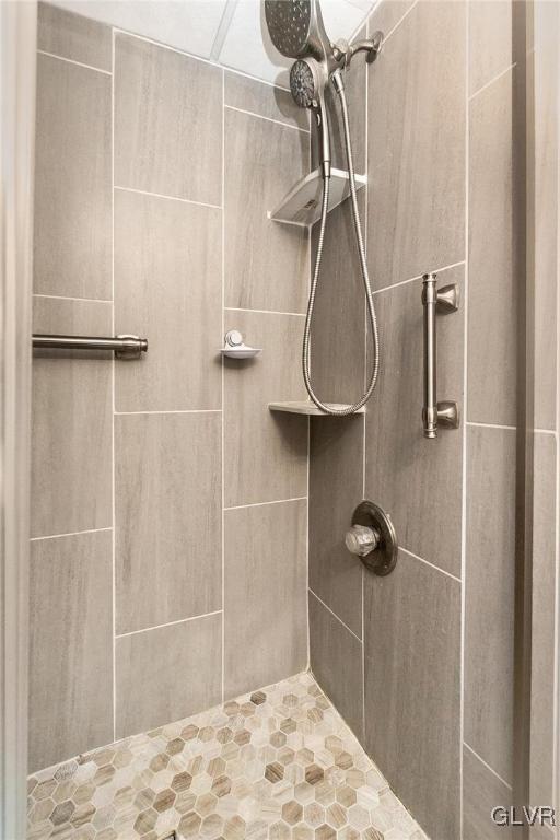 full bath with a tile shower