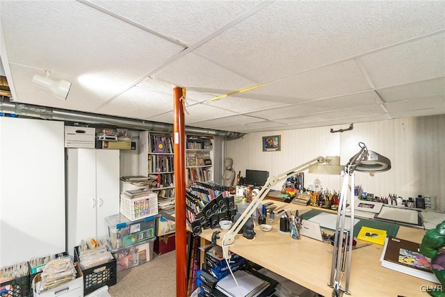 interior space with a paneled ceiling