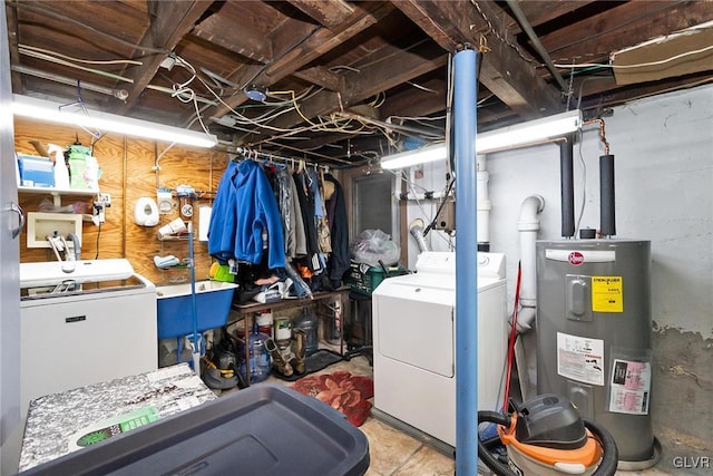 unfinished basement featuring water heater, fridge, and separate washer and dryer