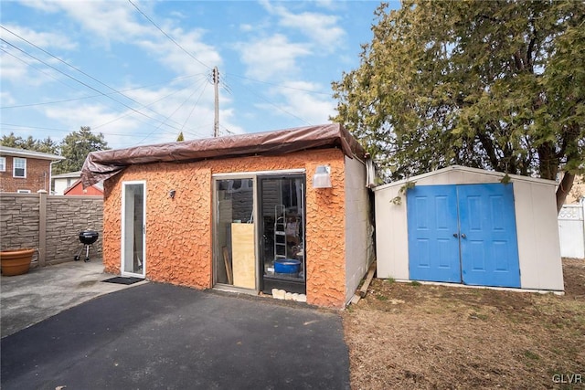 view of shed with fence