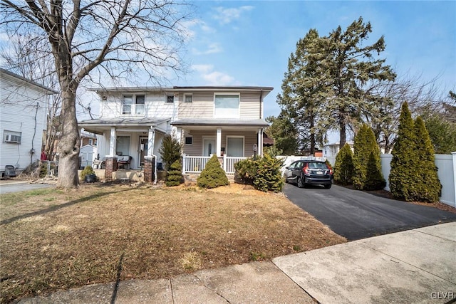 view of front of house featuring driveway and a porch