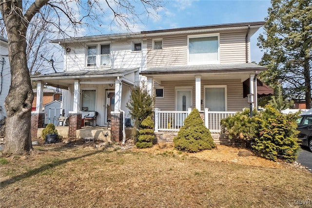 view of front of house with a front lawn and a porch