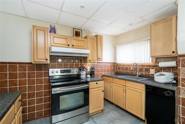 kitchen with under cabinet range hood, a sink, dishwasher, dark countertops, and stainless steel range with electric stovetop