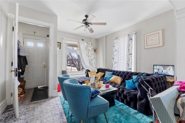 living room featuring ceiling fan and wood finished floors