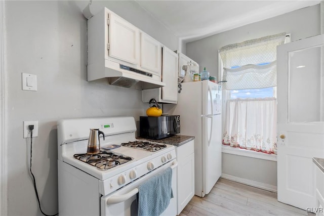 kitchen featuring light wood finished floors, white appliances, white cabinets, and under cabinet range hood