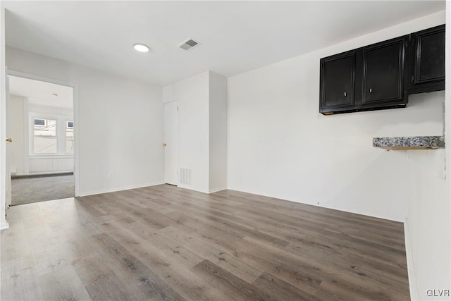 empty room with visible vents and wood finished floors