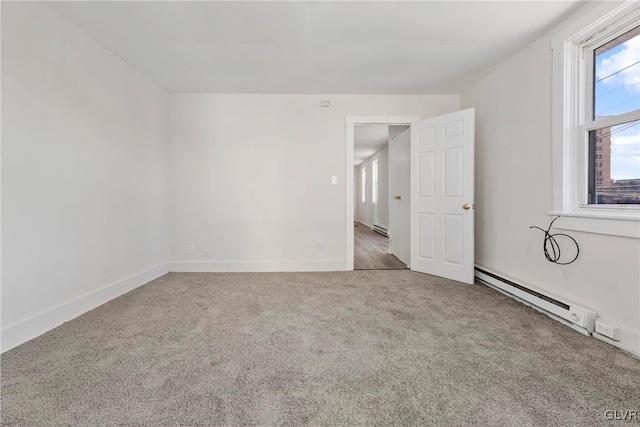 carpeted empty room with a baseboard radiator and baseboards