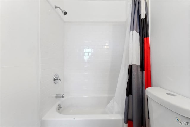 bathroom with shower / tub combo and toilet