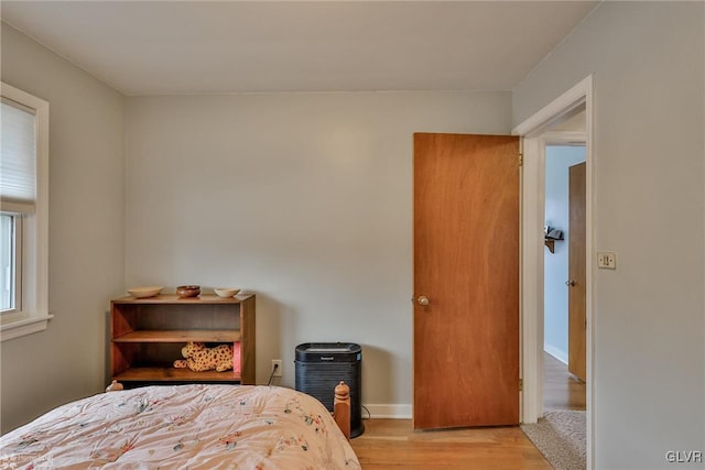 bedroom featuring light wood-type flooring and baseboards