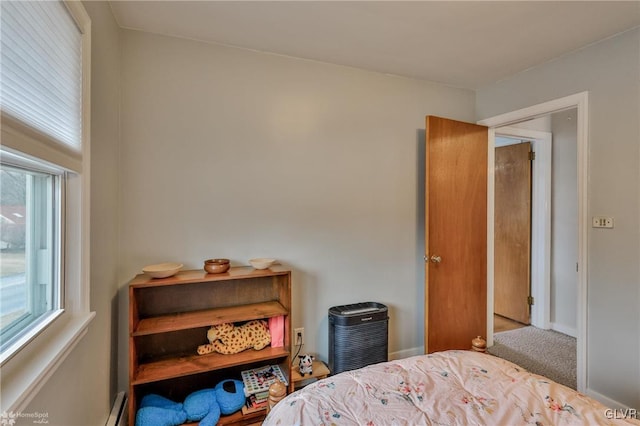 bedroom featuring carpet, baseboards, and baseboard heating