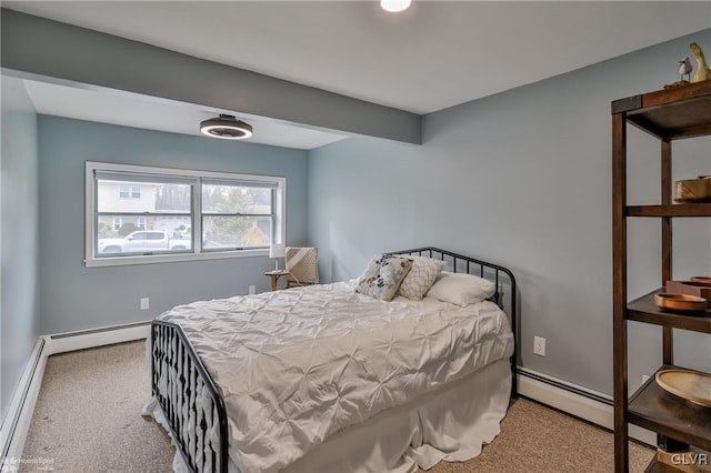 bedroom with a baseboard radiator, carpet flooring, and baseboards