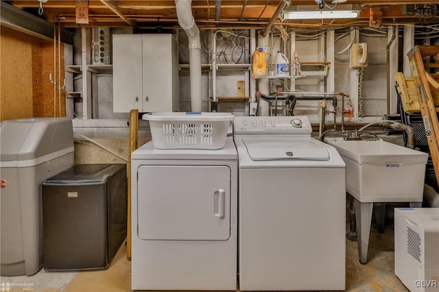 laundry room with laundry area, a sink, and washing machine and clothes dryer