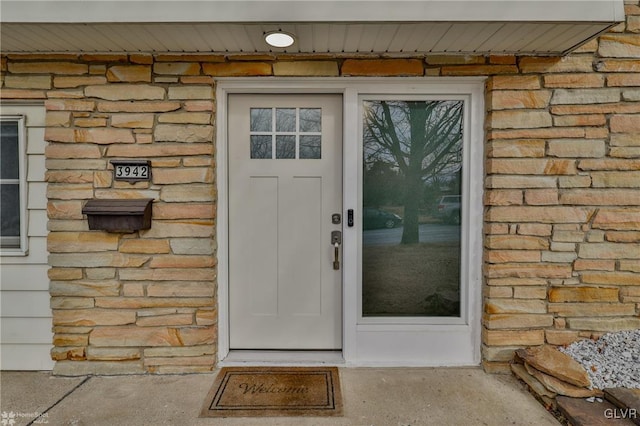 property entrance with stone siding