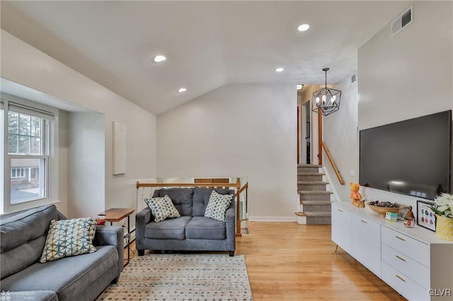 living area featuring light wood-style flooring, a notable chandelier, recessed lighting, visible vents, and vaulted ceiling