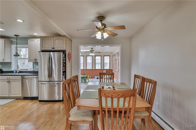 dining area featuring light wood-style floors, a baseboard radiator, baseboards, and recessed lighting