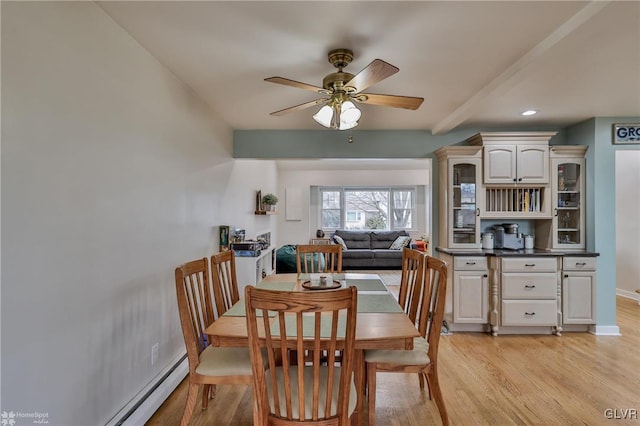 dining space with ceiling fan, recessed lighting, a baseboard heating unit, baseboards, and light wood finished floors