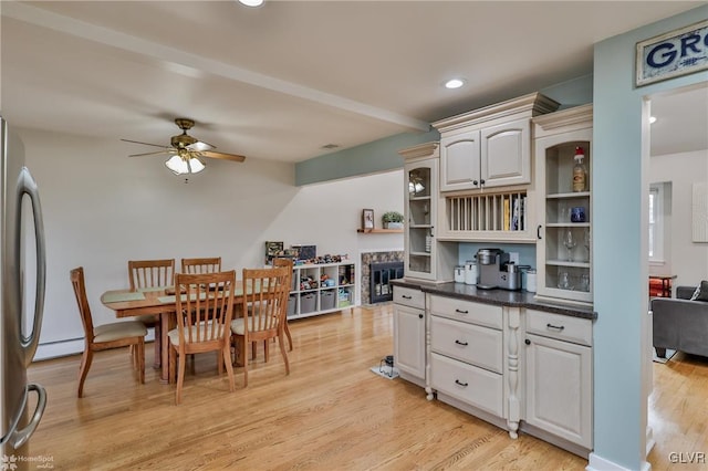 dining room featuring light wood-type flooring, a baseboard radiator, a ceiling fan, and recessed lighting