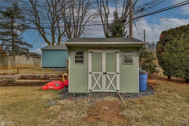 view of shed featuring fence