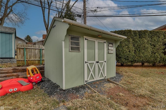 view of shed with fence