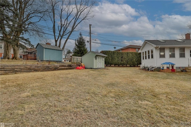 view of yard with a storage shed and an outbuilding