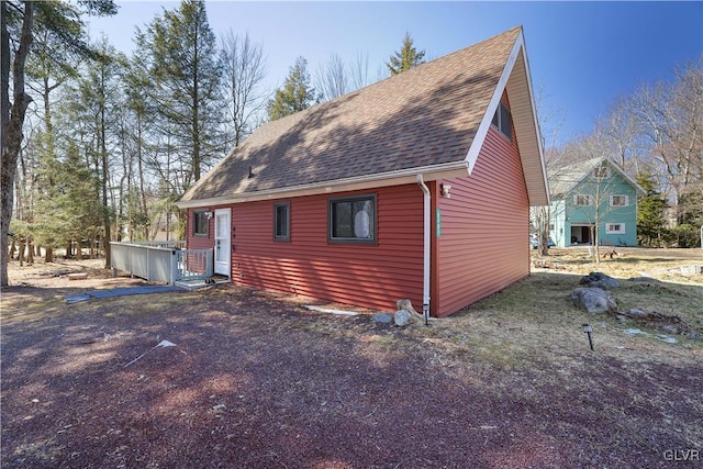 exterior space featuring a shingled roof