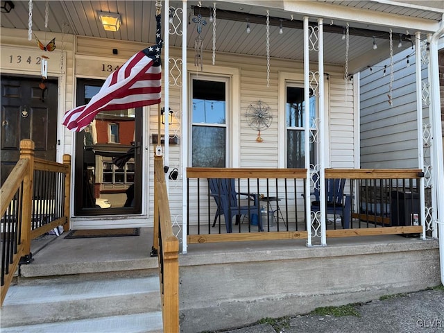 view of exterior entry with covered porch