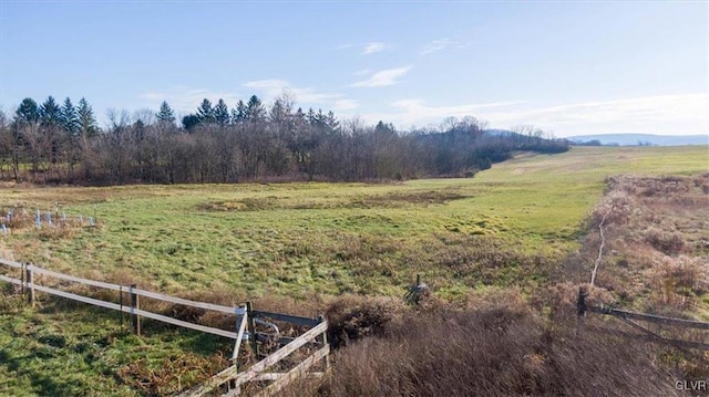 view of yard featuring a rural view and fence