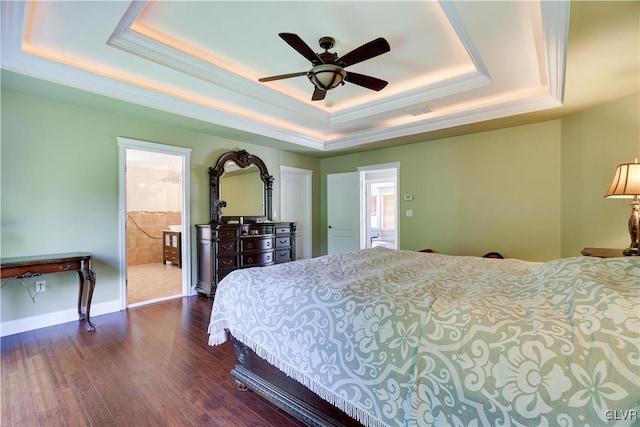 bedroom with baseboards, a ceiling fan, ornamental molding, dark wood-type flooring, and a tray ceiling