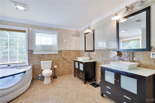 bathroom with ornamental molding, visible vents, a sink, and tile walls