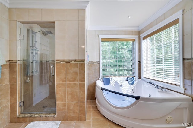 full bathroom featuring tile patterned flooring, tile walls, ornamental molding, a jetted tub, and a shower stall