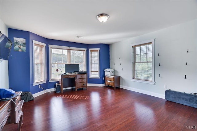 office area featuring wood finished floors, visible vents, and a healthy amount of sunlight