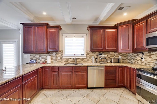 kitchen featuring dark brown cabinets, appliances with stainless steel finishes, a sink, and a wealth of natural light