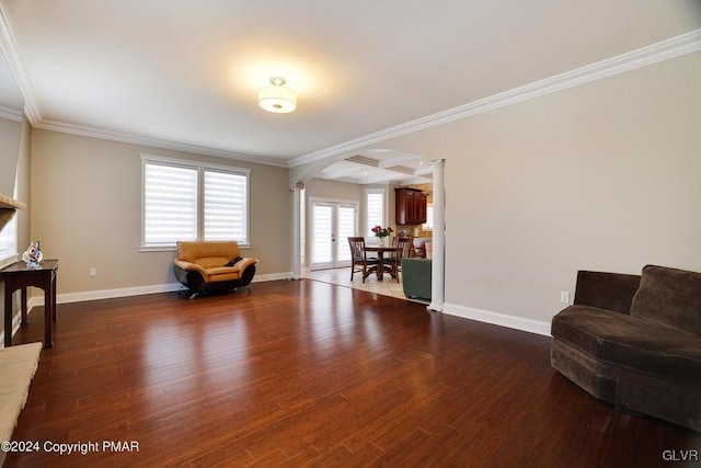 living area featuring ornamental molding and wood finished floors