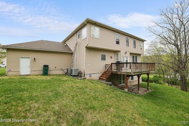 rear view of property featuring a deck, a yard, and central AC