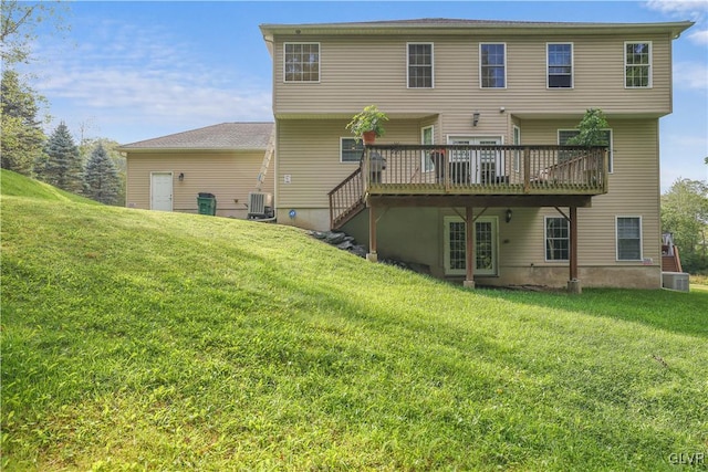 rear view of house with stairway, a wooden deck, central AC unit, and a yard