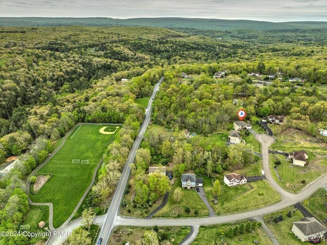 birds eye view of property with a wooded view