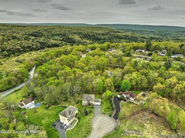 birds eye view of property with a view of trees