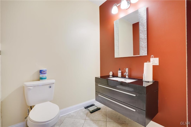 bathroom featuring toilet, vanity, baseboards, and tile patterned floors