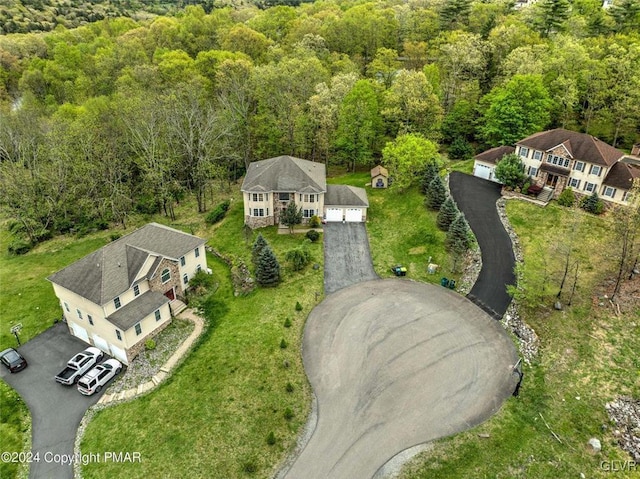 drone / aerial view featuring a forest view