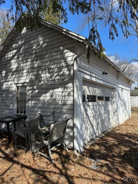 view of side of home featuring a garage