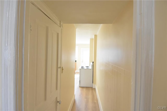 hallway with light wood-style floors and washer / clothes dryer