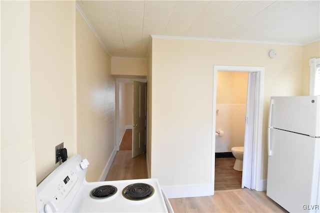 kitchen featuring white appliances, light wood-style flooring, ornamental molding, and baseboards