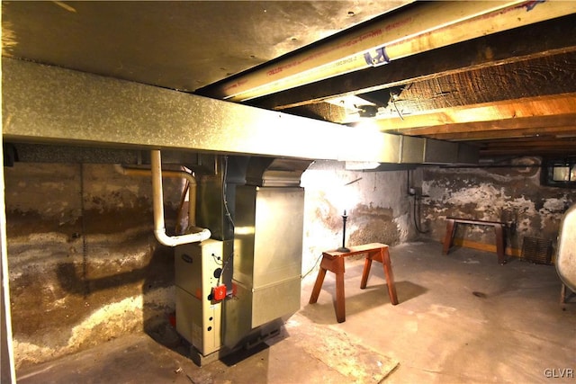 unfinished basement featuring heating unit