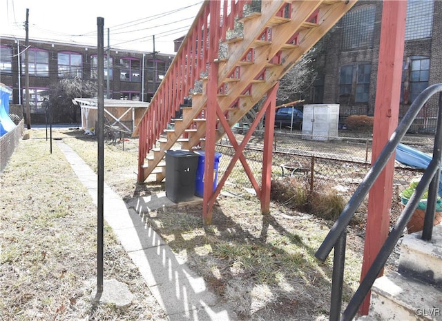 view of play area with stairway and fence