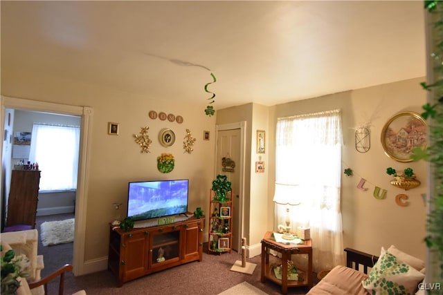 carpeted living room with plenty of natural light and baseboards