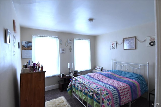 bedroom featuring carpet and baseboards